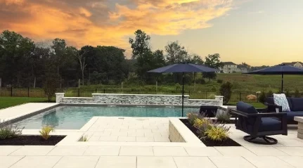 Natural stone pool deck with loungers